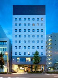 a large white building with a lot of windows at EN HOTEL Hamamatsu in Hamamatsu