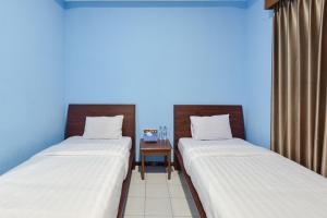 A bed or beds in a room at Sekar Ayu Hotel Malioboro Mitra RedDoorz