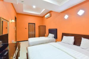A bed or beds in a room at Sekar Ayu Hotel Malioboro Mitra RedDoorz