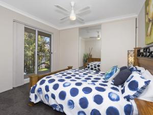 a bedroom with a bed and a ceiling fan at Lakeshore Apartments Unit 6 in The Entrance