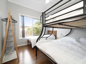 1 Schlafzimmer mit 2 Etagenbetten und einer Leiter in der Unterkunft Eloora House Blue bay in Long Jetty