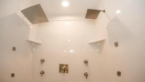 a bathroom with a shower with two lights on the wall at The Raspberry Garden in Rexburg