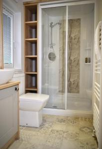 La salle de bains est pourvue d'une douche, de toilettes et d'un lavabo. dans l'établissement Lakewood retreat, à Woodhall Spa