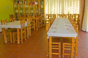 a row of tables and chairs in a restaurant at La Hospedería Del Silencio in Robledillo de la Vera +13 photos