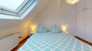 a bedroom with a blue bed with blue pillows at Alte Schule Spittelstein 1OG rechts in Rödental