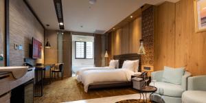 a hotel room with a bed and a bathroom at Hotel Château Anping in Tainan