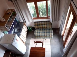 an overhead view of a living room with a couch and window at Pousada Praia Verde in Imbituba