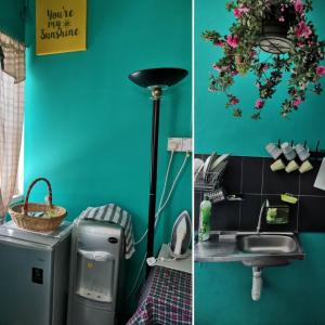 a bathroom with a blue wall and a sink at GH Great Homes in Kuching