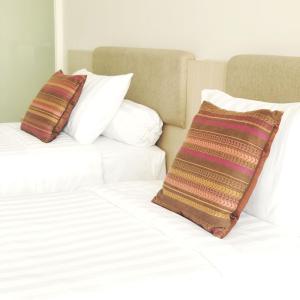 Postel nebo postele na pokoji v ubytování Skysuites Residence
