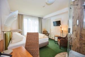 Postel nebo postele na pokoji v ubytování Flair Hotel Zum Schwarzen Reiter