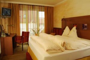Postel nebo postele na pokoji v ubytování Flair Hotel Zum Schwarzen Reiter