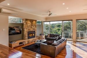 a living room with a couch and a fireplace at Glennishka in Margaret River Town