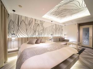 Postel nebo postele na pokoji v ubytování HOTEL U's 香櫨園