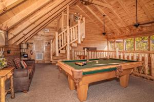 a living room with a pool table in a cabin at Brown Bear Lodge, Game Room, Awesome Mountain Views, Hot Tub, WIFI!!! in Sevierville