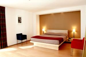 a bedroom with a bed and a dresser at Grand Hotel Tiziano E Dei Congressi in Lecce