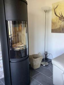 ヴェゾナにあるDorril SUNNY & QUIET chalet 10 pers by Alpvision Résidencesのランプ付きの客室内の黒い冷蔵庫