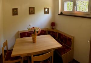 a dining room table with a vase of flowers on it at Casa Alice in Locarno +26 photos