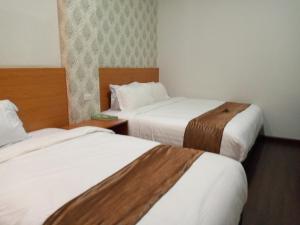 Katil atau katil-katil dalam bilik di Hotel Belangi Syariah Taakengon Mitra RedDoorz
