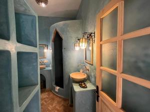 a bathroom with a sink and a mirror at Riad Baladin in Essaouira