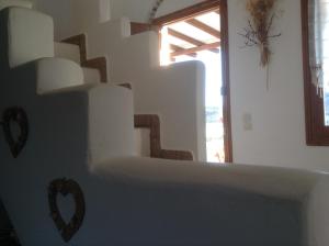 a room with a staircase with a heart on the wall at San Giorgio in Agios Georgios