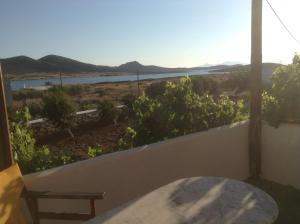 a balcony with a table and a view of the ocean at San Giorgio in Agios Georgios