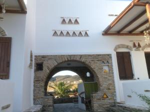 a building with an archway in the middle of a courtyard at San Giorgio in Agios Georgios