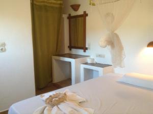a hotel room with a bed with a towel on it at San Giorgio in Agios Georgios