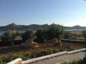 a garden with a lake and mountains in the background at San Giorgio in Agios Georgios