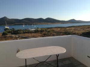 a bench on a balcony with a view of the water at San Giorgio in Agios Georgios