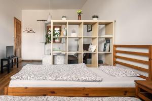 a bedroom with a bed and a book shelf at Penzion Oloffson in Počátky