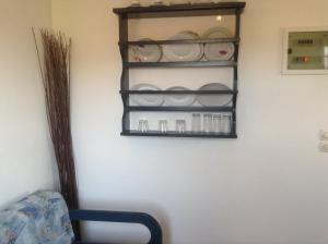 a shelf on a wall with dishes on it at San Giorgio in Agios Georgios