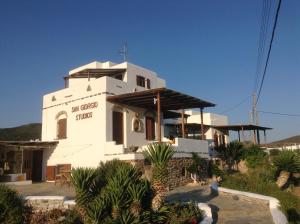 a white church with a sign on the side of it at San Giorgio in Agios Georgios