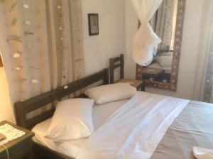 a bedroom with a bed and a large mirror at San Giorgio in Agios Georgios
