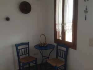 a room with two chairs and a table and a window at San Giorgio in Agios Georgios