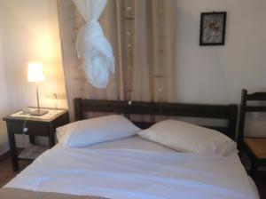 a bed with two white pillows in a bedroom at San Giorgio in Agios Georgios