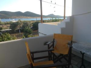 a balcony with two chairs and a table and a view at San Giorgio in Agios Georgios