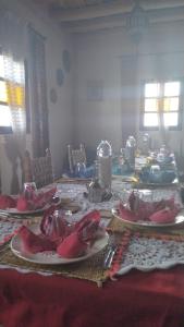 a dining room table with plates of food on it at Riad Gabsi Dades in Boumalne