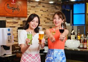 two women standing next to each other holding drinks at Hotel Kusakabe Armeria in Gero