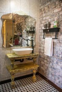 uma casa de banho com um lavatório e uma parede de tijolos em La Casa Nostra Villa Rose Garden Amore em Hillcrest