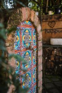 a colorful door in a brick wall with graffiti at La Casa Nostra Villa Rose Garden Amore in Hillcrest