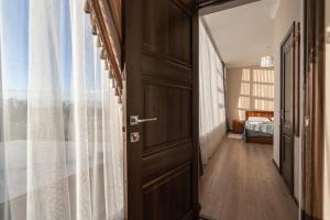 an open door in a room with a bedroom at Muras Hotel Karakol in Karakol