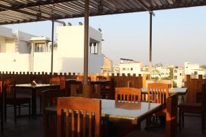 a restaurant with tables and chairs and a view of the city at Hotel Heritage High in Udaipur