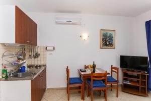 a kitchen with a table and chairs and a kitchen with a sink at K-apartments in Dubrovnik