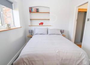 een slaapkamer met een groot wit bed in een kamer bij Meadow View at Keepers Cottage in Eaton