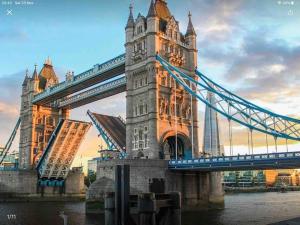 a suspension bridge in london over the water at Remarkable Apartment near London Tower Bridge in London