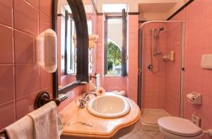 a bathroom with a sink and a shower and a toilet at Hotel San Valentino Terme in Ischia