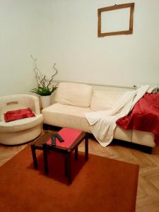 a living room with a white couch and a table at Sunshine house in Pančevo