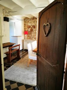 a heart shaped door in a kitchen with a table at Villers la villA in Villers-la-Ville