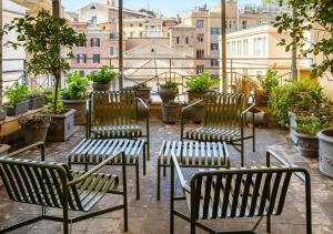 a row of tables with chairs and umbrellas at Condominio Monti Boutique Hotel in Rome