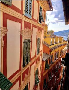 a building with green shutters on the side of it at Camogli Eden - Luxury apartment in Camogli